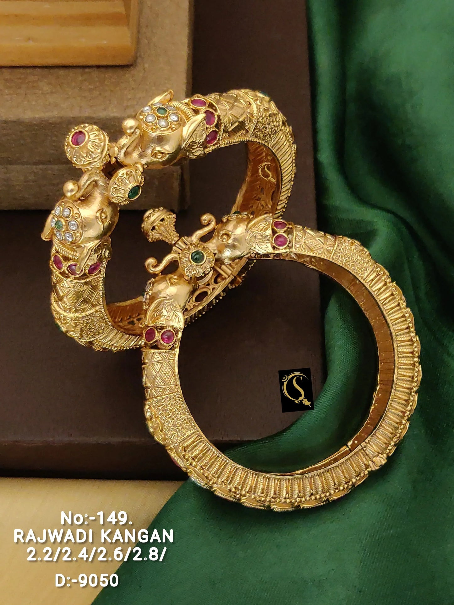 Pair of gold Rajwadi Kangan bangles with intricate elephant head design and embedded gemstones