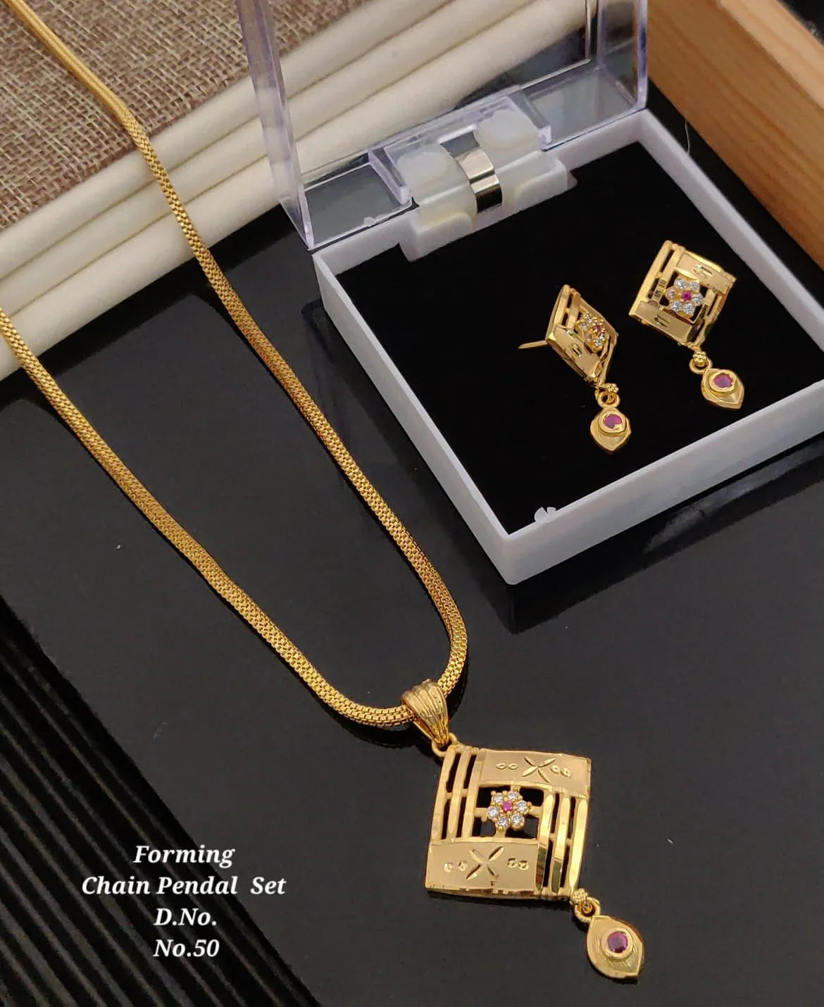 Gold chain pendant set with square floral design and ruby accents, jewelry gift box included