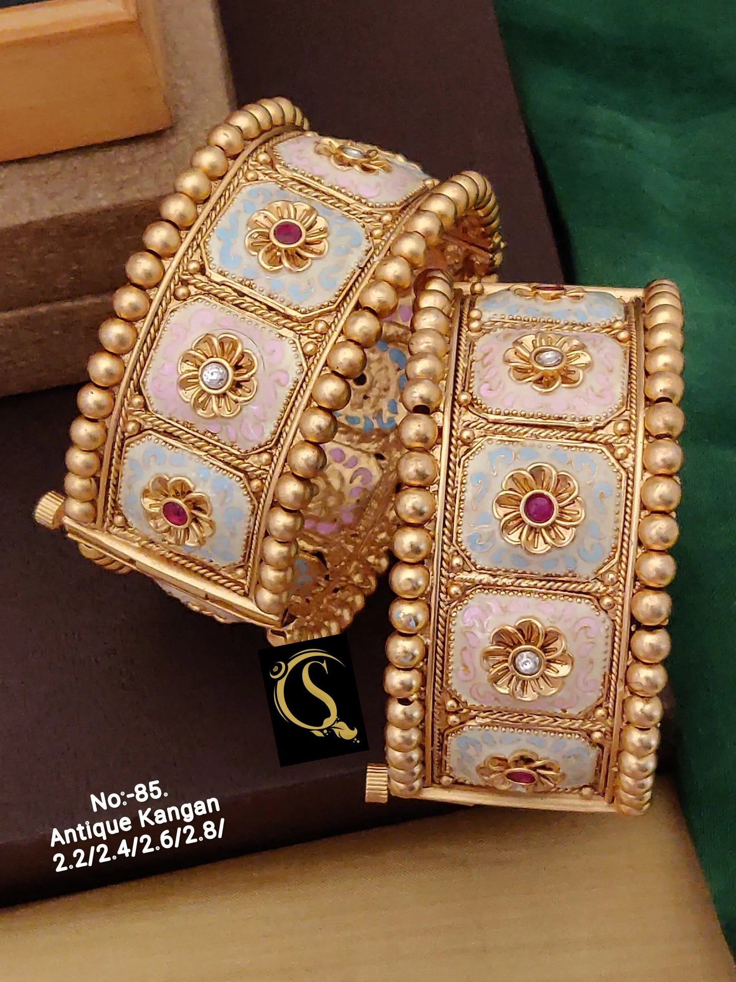 Pair of antique gold Kangan bracelets with colorful enamel and floral stone details
