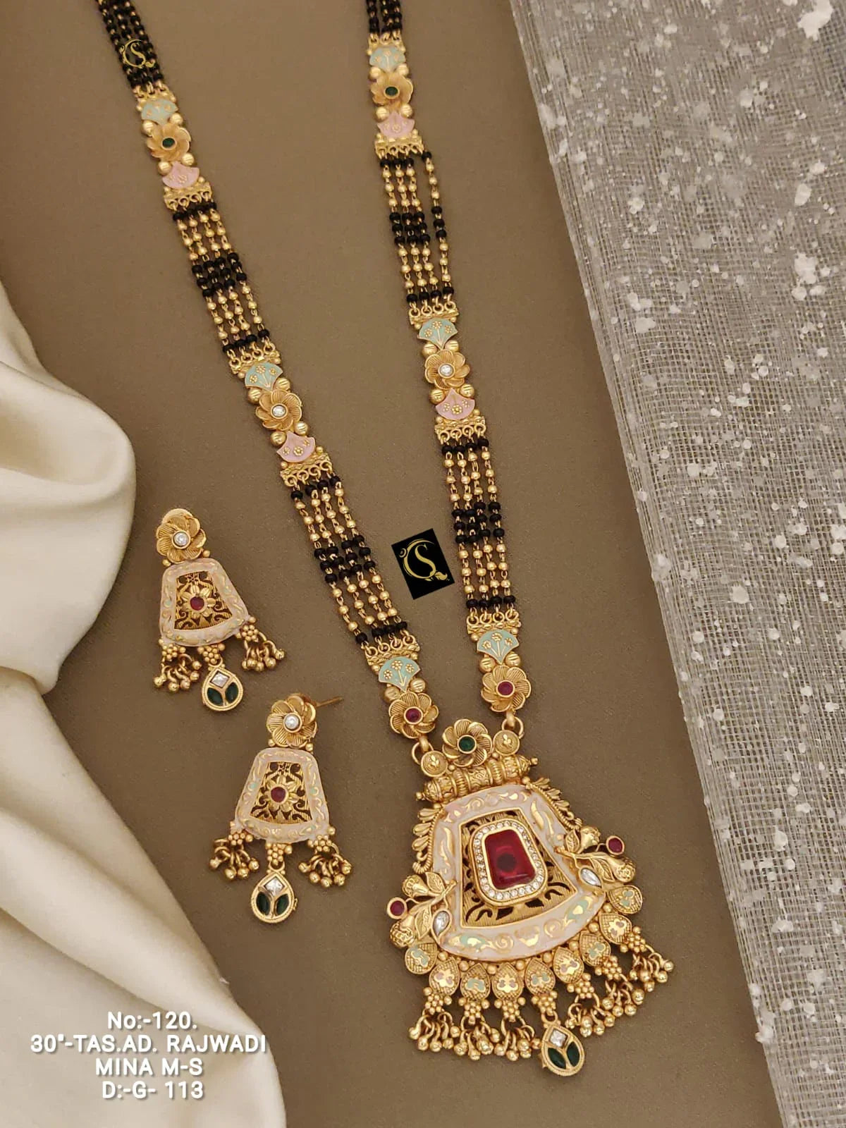 Gold Rajwadi necklace and earrings set with black beads, colorful enamel work, and red stone centerpiece