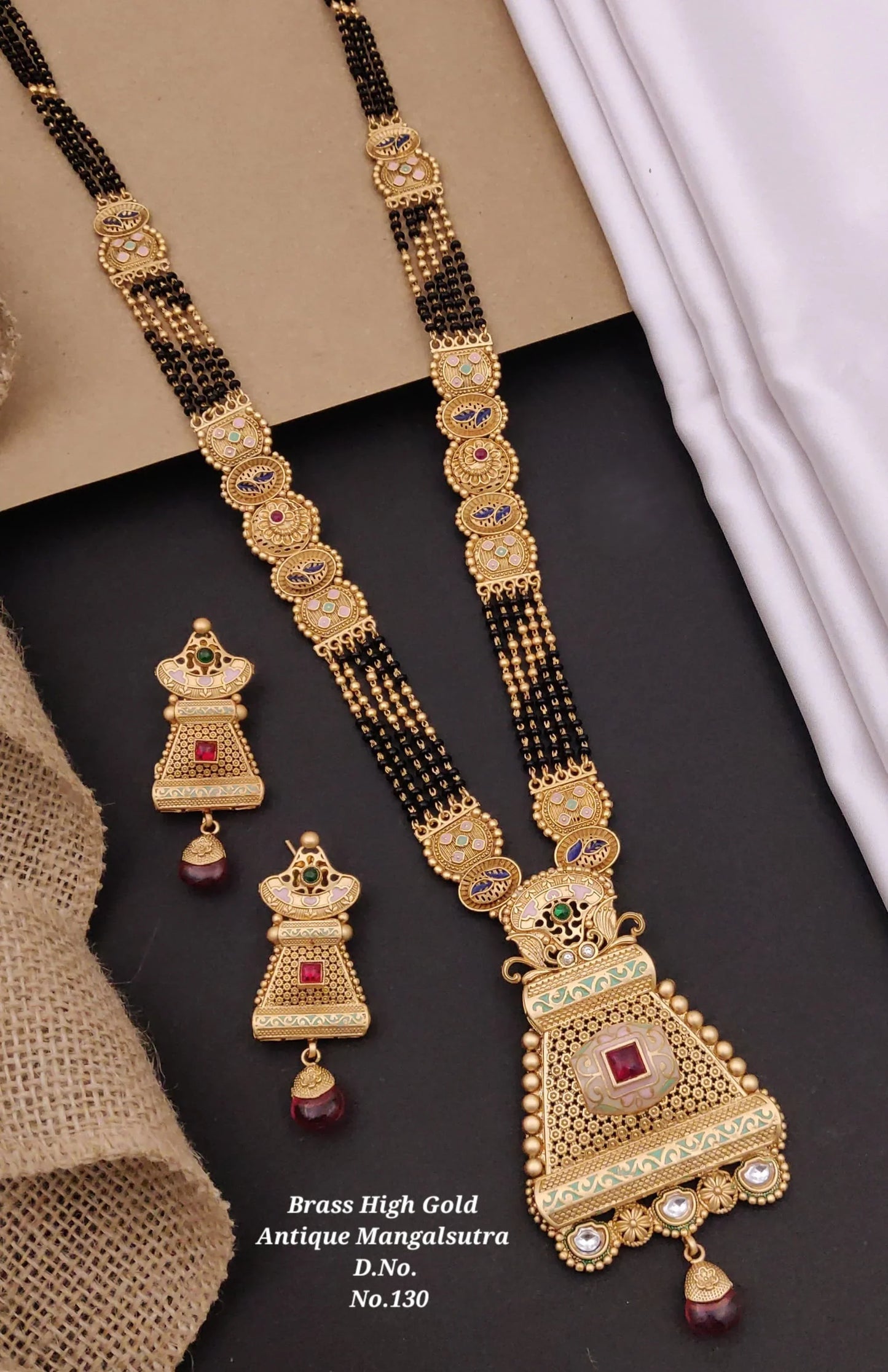 Brass high gold antique mangalsutra necklace with black beads and matching earrings with red and green stones