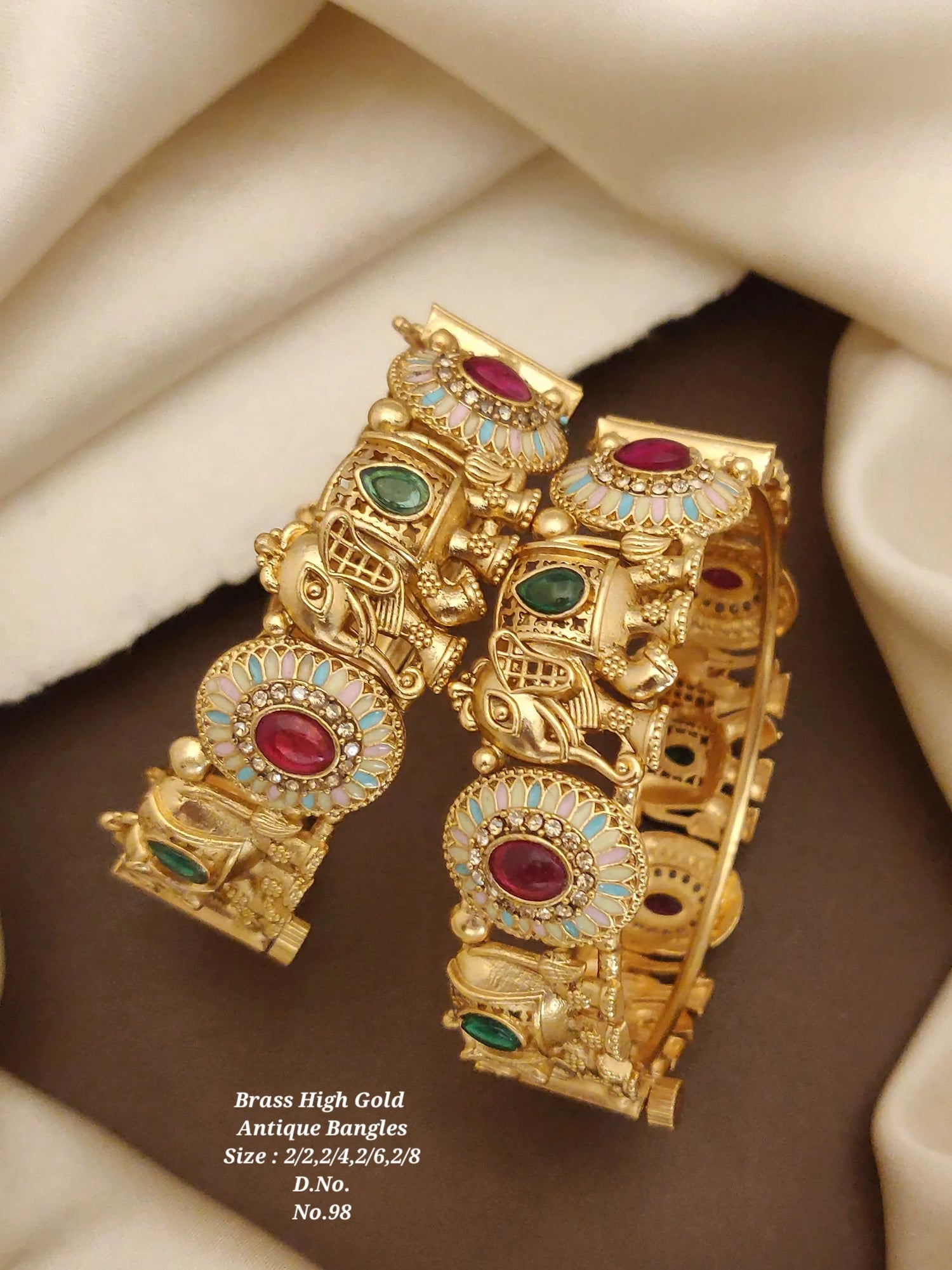Antique brass high gold bangles with red and green stones and intricate elephant designs
