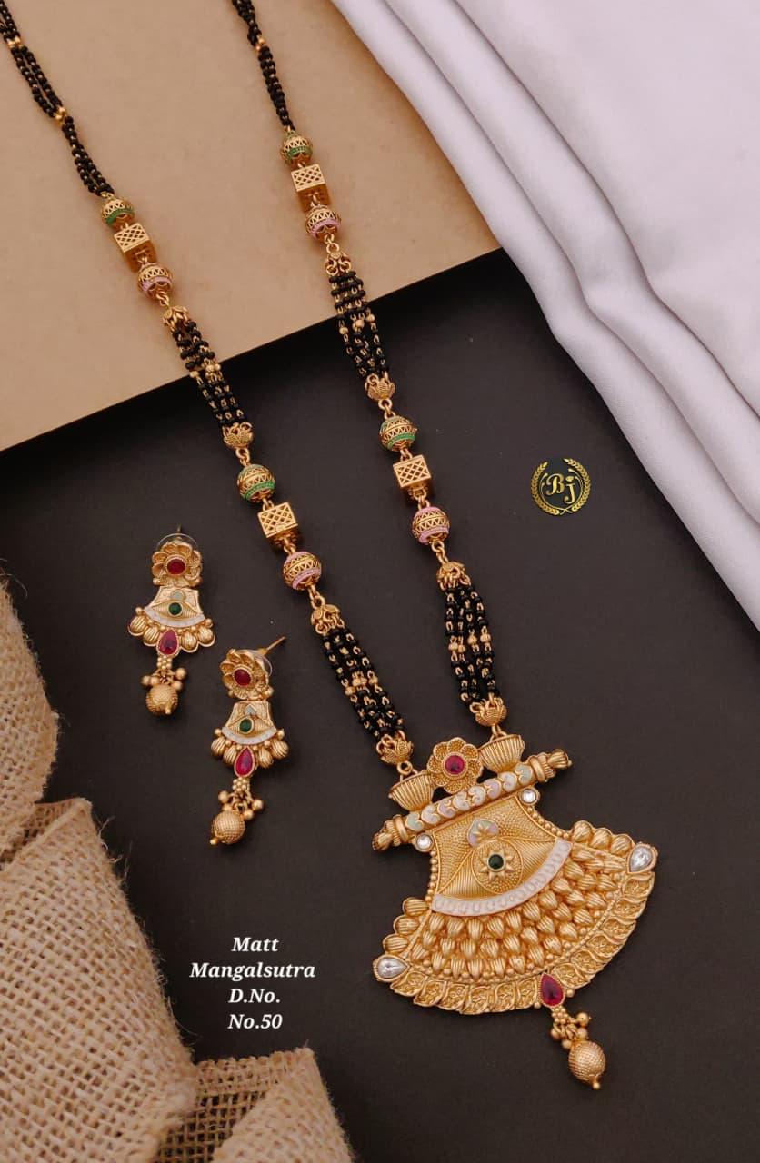 Traditional matte gold mangalsutra with black beads and matching gold earrings with red and green stones