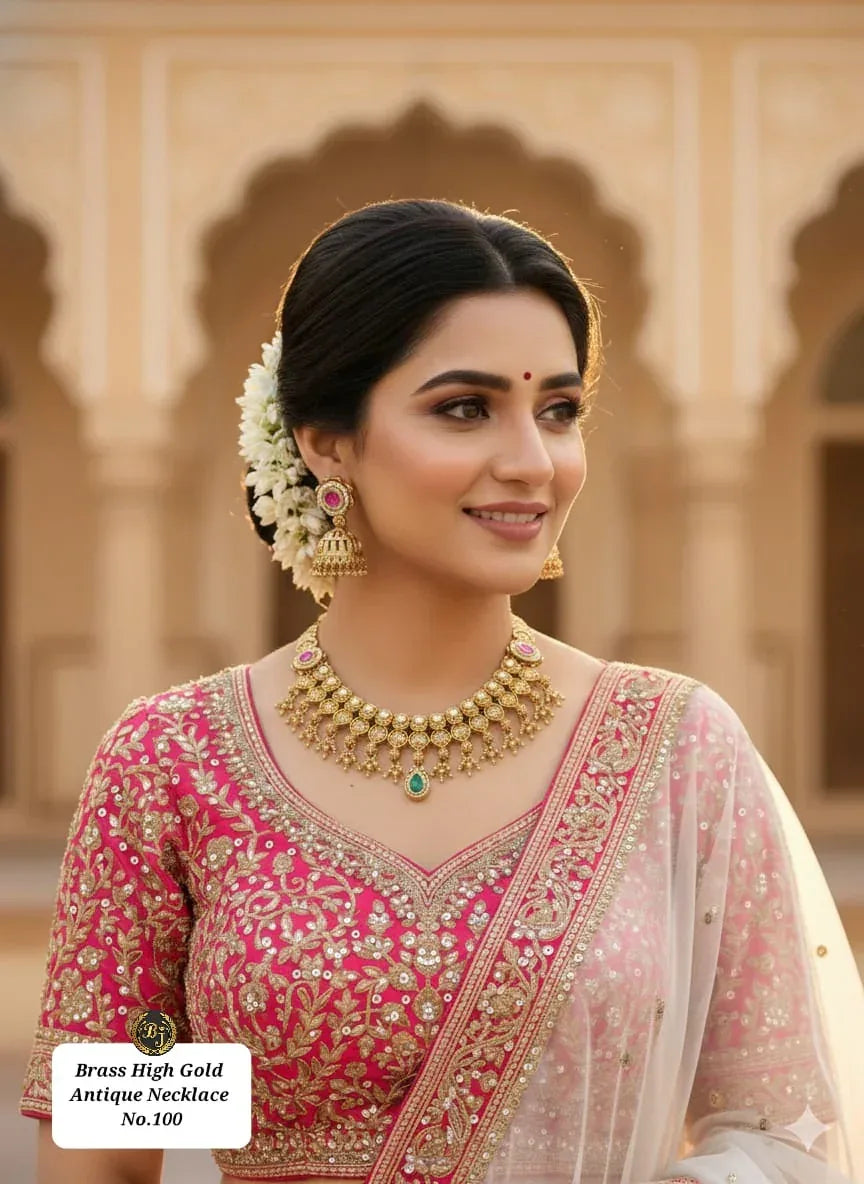 Woman in traditional Indian attire wearing ornate brass high gold antique necklace and matching earrings