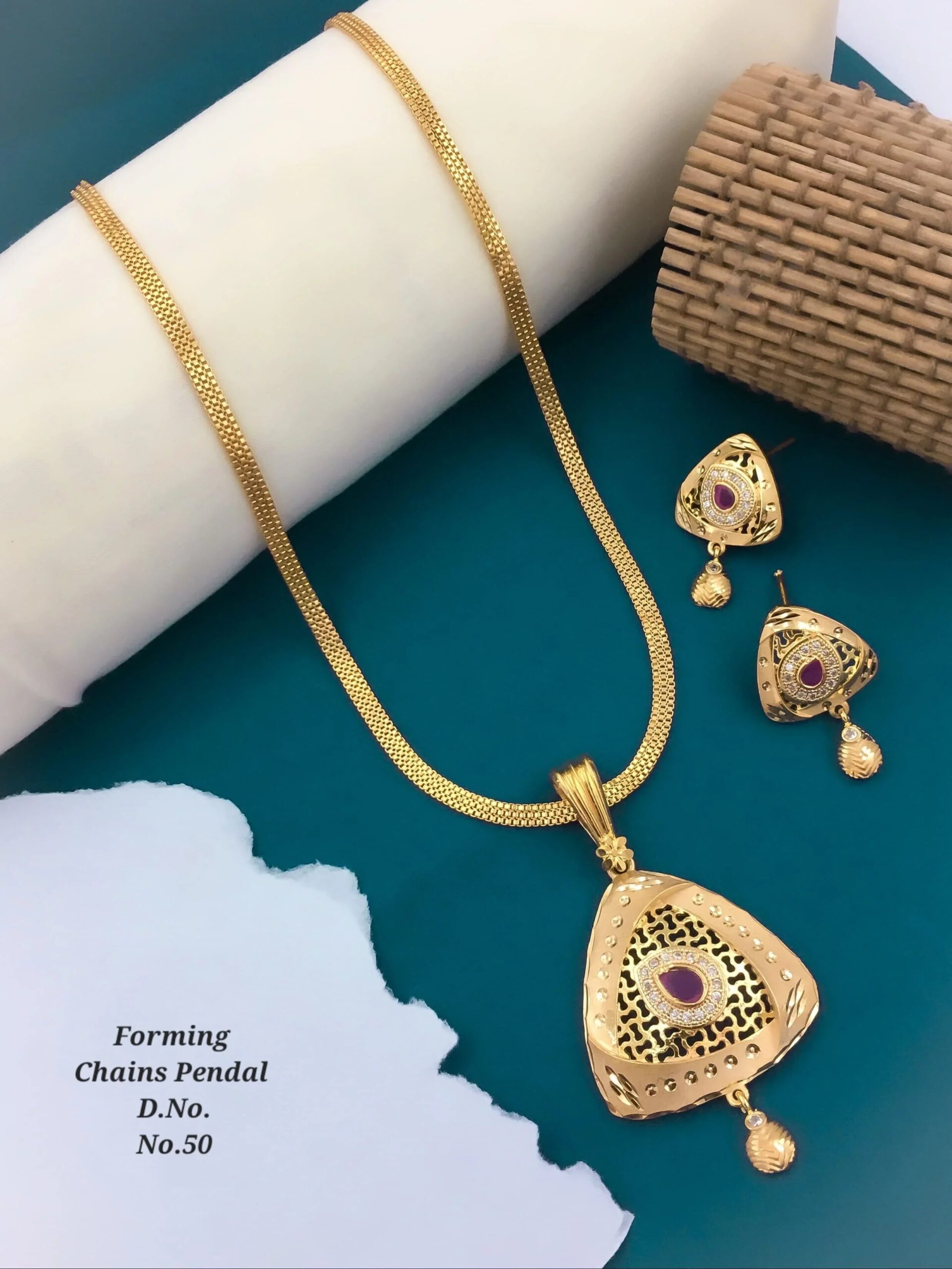 WhatsAppImage2024-07-11at13.59.55 Gold chain necklace with triangular pendant and matching earrings featuring purple stones on blue background