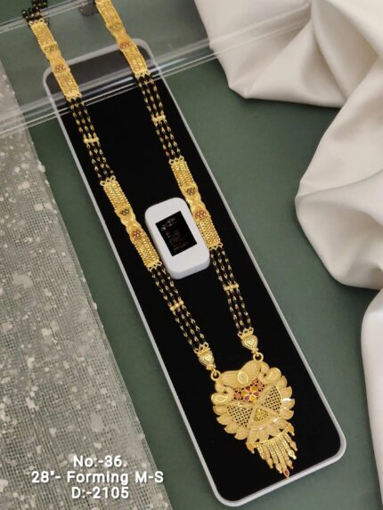 Traditional gold mangalsutra necklace with black beads and intricate pendant in black jewelry box