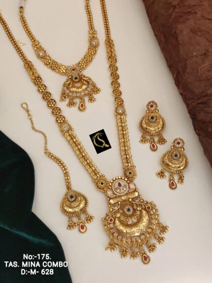 golden traditional Indian necklace set with intricate designs and matching earrings on white background