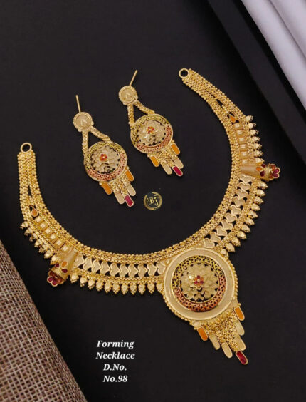 Intricate gold forming necklace and matching earrings with floral design and red accents on black background