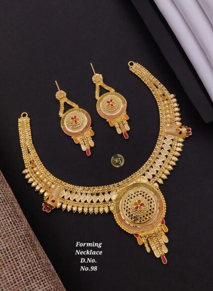 Intricate gold forming necklace and matching earrings with red and orange accents on black background
