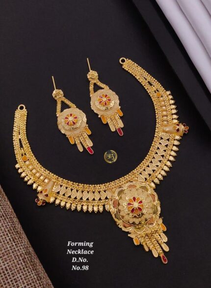 Gold necklace and matching earrings set with floral design and red, yellow enamel accents on black background