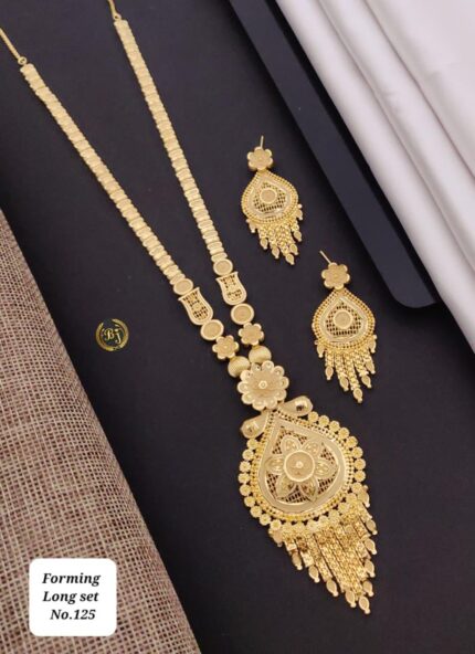 Intricate gold forming long necklace set with matching floral earrings on black background